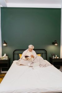 pexels-photo-8376204-8376204 Elderly woman in bed using tablet for online medical consultation with medication.